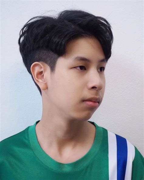 The two-block haircut is a popular hairstyle in South Korea. It’s called such because the style entails separating the hair into two blocks: longer hair on the crown and an undercut around the sides and back. It requires a bit of styling, but it’s rather easy to maintain and suits most face shapes.